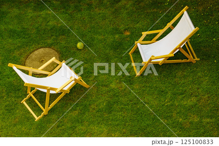 Deck chairs in garden 125100833