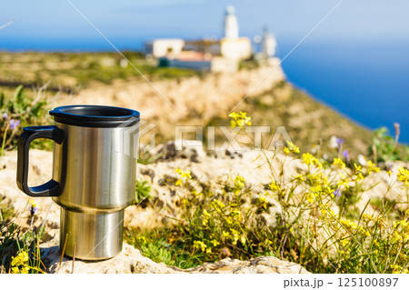 Thermal mug, thermos on nature. Travel outdoor picnic. Thermal mug, thermos on nature. Travel outdoor picnic. 125100897
