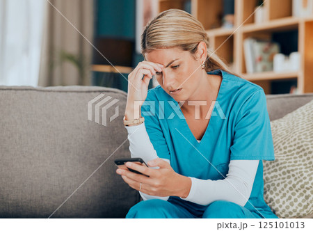 Phone, healthcare and worry with a woman nurse reading a text message while sitting on a sofa in a hospital office. Mobile, medicine and medical with a female health professional receiving bad news Phone, healthcare and worry with a woman nurse reading a text message while sitting on a sofa in a hospital office. Mobile, medicine and medical with a female health professional receiving bad news 125101013