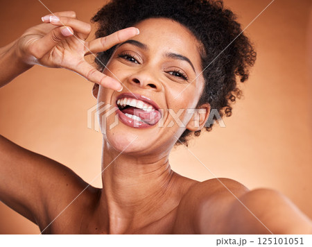 Selfie, beauty and portrait of black woman with peace sign for luxury face skincare, healthy body care or wellness routine. Crazy photo expression, cosmetics makeup and model with emoji hands gesture Selfie, beauty and portrait of black woman with peace sign for luxury face skincare, healthy body care or wellness routine. Crazy photo expression, cosmetics makeup and model with emoji hands gesture 125101051