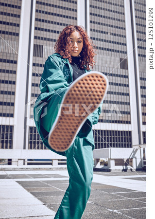 Fashion, city and model with a black woman on a rooftop, kicking air in contemporary clothing. Street style, portrait and confidence with an attractive young female outdoor to promote trendy style Fashion, city and model with a black woman on a rooftop, kicking air in contemporary clothing. Street style, portrait and confidence with an attractive young female outdoor to promote trendy style 125101299