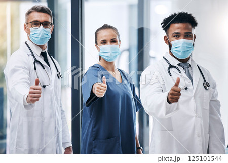 Hospital, team and thumbs up for medical support in healthcare success. Mask, yes and covid safety compliance winner or clinic teamwork happiness in doctor laboratory office for clinical achievement 125101544