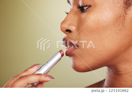 Makeup, black woman with lipstick for lips in cosmetic closeup, face profile with cosmetics product advertising against studio background. Healthy skin glow, lip care and wellness with beauty mock up Makeup, black woman with lipstick for lips in cosmetic closeup, face profile with cosmetics product advertising against studio background. Healthy skin glow, lip care and wellness with beauty mock up 125101662