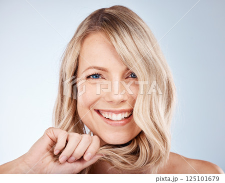 Face, beauty and hair with a model woman in studio on a gray background for natural haircare treatment. Skincare, cosmetics and hairstyle with an attractive young female posing to promote keratin 125101679