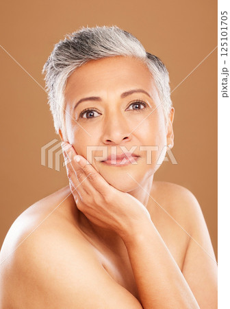 Skincare, wellness and portrait of senior black woman isolated in studio on orange background. Beauty, cosmetics and old female pose for anti aging beauty products, skincare products and body care 125101705