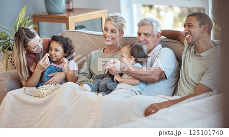Family, children and watching tv grandparents, parents and kids together on a sofa in the living room of their home. Movie, television and film with a man, woman and grandkids bonding over a video 125101740