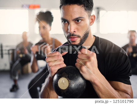Strong man, personal trainer and group training with kettlebell squat exercise, workout and fitness in gym club. Bodybuilder coach teaching sports class with heavy weights, challenge and powerlifting 125101790