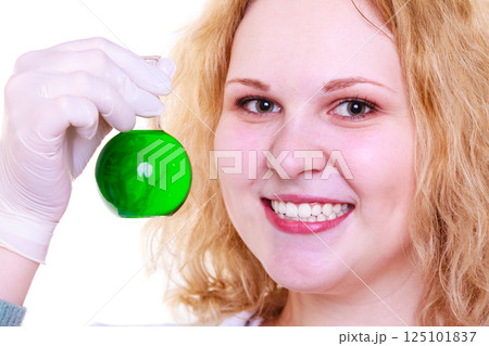 Chemist woman holds test flask 125101837