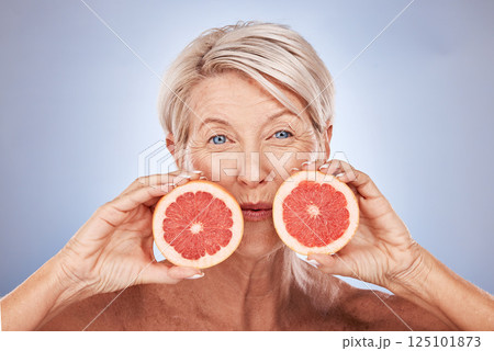 Natural, portrait and senior wellness with grapefruit for skin, beauty and aging treatment. Skincare, mature and health model for vitamin c fruit cosmetic advertising with gray studio mockup. 125101873
