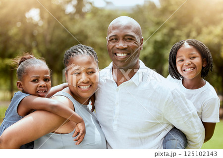 Black family, piggyback and children with a mother and father carrying their daughter siblings outdoor in a park. Portrait, happy and love with a man, woman and kids bonding together in nature 125102143