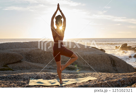 Peace, yoga and sunset with woman at beach on rocks for fitness, zen and meditation wellness. Relax, spiritual and faith with girl training by ocean for balance, workout or breathing health in nature Peace, yoga and sunset with woman at beach on rocks for fitness, zen and meditation wellness. Relax, spiritual and faith with girl training by ocean for balance, workout or breathing health in nature 125102321
