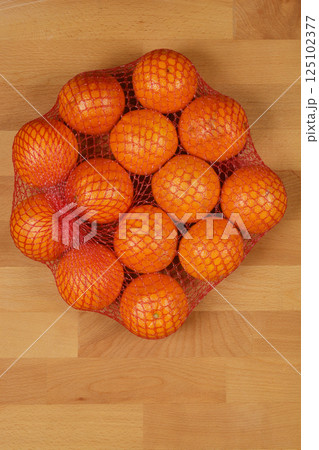 Oranges in a red net bag 125102377