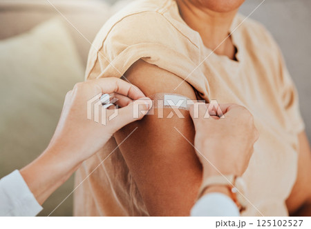 Healthcare, doctor and patient with covid vaccine injection plaster on arm for immune medicine, bandaid and medical treatment to prevent disease. Clinic vaccination, safe and healthy woman after shot 125102527