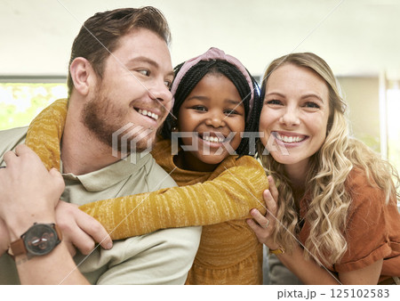 Family, adoption and parents hug child, love and happiness with child care portrait, relax at family home. Happy, bonding and interracial people with foster care and mother, father with kid. Family, adoption and parents hug child, love and happiness with child care portrait, relax at family home. Happy, bonding and interracial people with foster care and mother, father with kid. 125102583