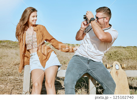 Couple outdoor, man and woman with camera for photo, happiness and adventure together in nature. Photography, skateboard and road trip with happy, smile and pose on vacation, holiday or travel in sun 125102740