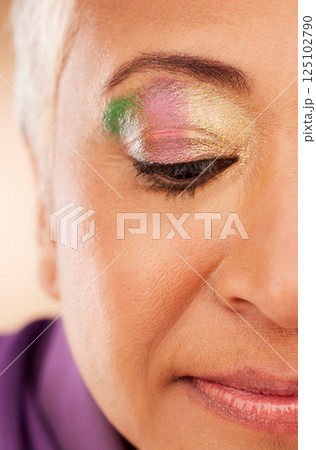 Eyeshadow, eye and mature woman for beauty, cosmetics and skin wellness with creative aesthetic. Cosmetic zoom, senior model or rainbow art on face for skincare, fashion or style by studio background Eyeshadow, eye and mature woman for beauty, cosmetics and skin wellness with creative aesthetic. Cosmetic zoom, senior model or rainbow art on face for skincare, fashion or style by studio background 125102790