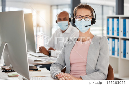 Covid, call center and portrait in office with medical mask for safety, health and protection from virus at pc. Consultant, telemarketing and workplace people with corona face mask at computer. Covid, call center and portrait in office with medical mask for safety, health and protection from virus at pc. Consultant, telemarketing and workplace people with corona face mask at computer. 125103023
