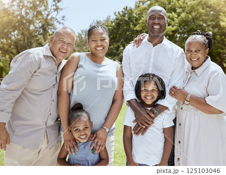 Portrait of happy black family with smile in park, garden or outdoor picnic venue. Men, women and kids together on grass at family event and making memories, generations with girl children and couple 125103046