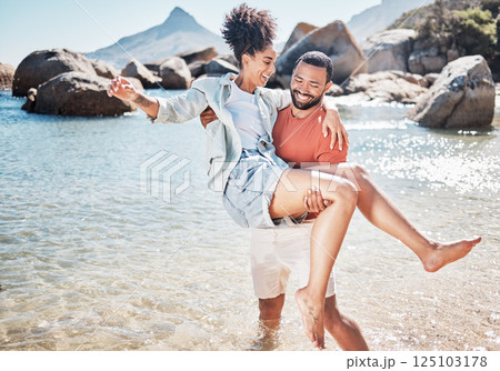 Couple, beach and man carrying woman for love, marriage support and funny holiday vacation. Travel, quality time together and summer freedom in Hawaii, sunshine and relax on ocean sand for happiness 125103178