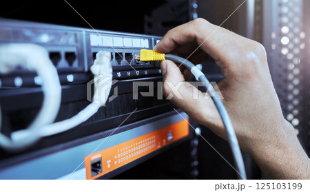 Hands, network engineer and server cable in server room for data, internet or web connection. Cyber security, system administrator and maintenance of computer wire to prevent error, glitch or issues 125103199