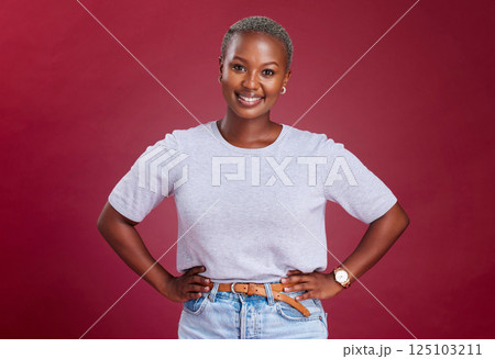 Young, african woman and hands on hips in studio for beauty, fashion and style with happiness. Happy black woman, portrait pose or smile face against red background for cosmetics, makeup or glow skin Young, african woman and hands on hips in studio for beauty, fashion and style with happiness. Happy black woman, portrait pose or smile face against red background for cosmetics, makeup or glow skin 125103211