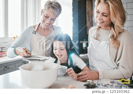 Family, children and baking with a grandmother, mother and daughter in the kitchen together for learning. Food, cooking and kids with a woman, parent and girl bonding in the house to bake a pastry 125103362