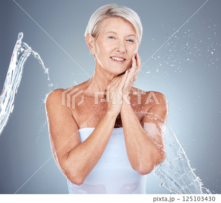 Skincare, water splash and portrait of senior woman in studio for wellness, healthy skin and hydration. Beauty, spa and old woman with water stream for cleansing, facial and moisturizing products 125103430