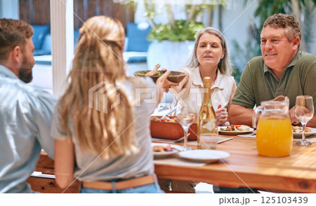 Family, food and eating people with champagne, lunch and outdoor patio for holiday, celebration or reunion BBQ. Family grandparents with table food, barbecue and wine or alcohol to celebrate together Family, food and eating people with champagne, lunch and outdoor patio for holiday, celebration or reunion BBQ. Family grandparents with table food, barbecue and wine or alcohol to celebrate together 125103439