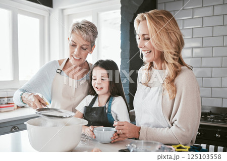 Family, baking and cooking together in a home kitchen with mother, grandmother and child learning about food and being a chef of baker. Woman, senior and girl helping with flour for pancakes or cake Family, baking and cooking together in a home kitchen with mother, grandmother and child learning about food and being a chef of baker. Woman, senior and girl helping with flour for pancakes or cake 125103558