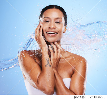 Shower, water and black woman with splash and beauty, grooming and hygiene with clean and wet against blue studio background. Natural cosmetics, fresh and hydration, wellness and healthy skin mockup. Shower, water and black woman with splash and beauty, grooming and hygiene with clean and wet against blue studio background. Natural cosmetics, fresh and hydration, wellness and healthy skin mockup. 125103689