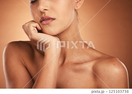 Beauty, skincare and closeup of a woman in a studio with a natural skin routine for wellness. Cosmetics, face and face of a model with a facial treatment isolated by a gradient brown background. Beauty, skincare and closeup of a woman in a studio with a natural skin routine for wellness. Cosmetics, face and face of a model with a facial treatment isolated by a gradient brown background. 125103738