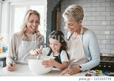 Family, children and baking with a mother, grandmother and girl in the kitchen of their home together. Food, kids and bake with a woman, parent and female child learning about cooking while bonding 125103739
