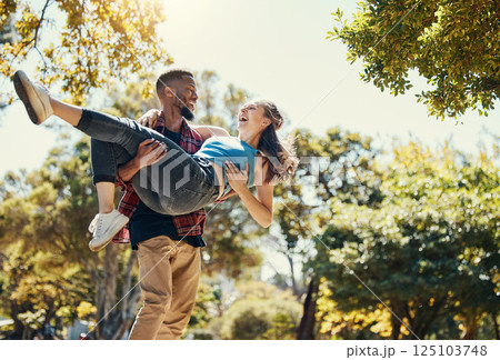 Young interracial couple, park and man carrying woman on summer date in garden, sunshine fun or relax, love and care together. Happy couple, smile and diversity people in nature for relationship play Young interracial couple, park and man carrying woman on summer date in garden, sunshine fun or relax, love and care together. Happy couple, smile and diversity people in nature for relationship play 125103748