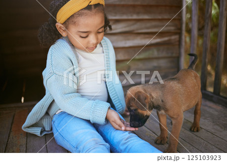 Child, puppy dog and smell hand for trust, friendship and love of new, domestic animal adoption and child development. Pet shelter, friendly german shepherd and girl learning pet care while bonding 125103923