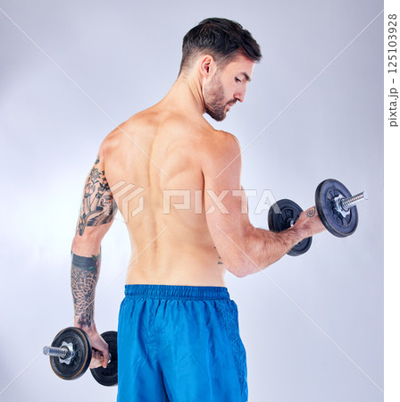 Bodybuilder back, dumbbells and background in studio for fitness, health or training with focus. Man, weightlifting exercise and sport workout for body, power and muscle with iron for bodybuilding 125103928