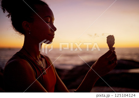 Sunset meditation, woman relax in by beach and ocean for zen peace focus, chakra wellness and mental health by the sea. Burning sage in nature, aromatherapy and spiritual mindfulness health exercise Sunset meditation, woman relax in by beach and ocean for zen peace focus, chakra wellness and mental health by the sea. Burning sage in nature, aromatherapy and spiritual mindfulness health exercise 125104124