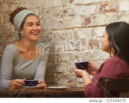 Business meeting, coffee or friends networking in restaurant or cafe for communication, planning or talking for startup company. Happy, women or consulting people for social business strategy in cafe 125104270