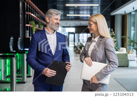 Entrepreneur and businessman standing in workplace discussing partnership 125104313