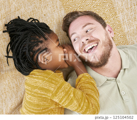 Happy, whisper secret and child in an interracial family with father with a smile about adoption above. Dad, girl and kid care of a man with happiness, love and parent care on a home carpet bonding Happy, whisper secret and child in an interracial family with father with a smile about adoption above. Dad, girl and kid care of a man with happiness, love and parent care on a home carpet bonding 125104502