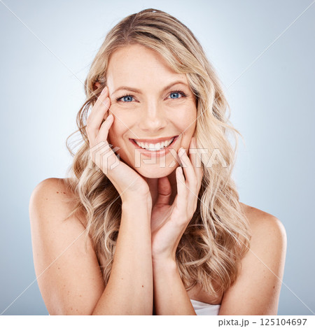 Beauty portrait, face and skincare of woman in studio on gray background. Makeup, aesthetics or natural cosmetics of female model from Canada touching skin for facial wellness and skin health routine 125104697