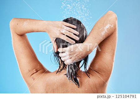 Hair, wash and woman in shower with water for haircare, cleaning and health on a blue studio background. Bathroom, cleansing and hygiene for hair grooming with shampoo or soap while showering Hair, wash and woman in shower with water for haircare, cleaning and health on a blue studio background. Bathroom, cleansing and hygiene for hair grooming with shampoo or soap while showering 125104791