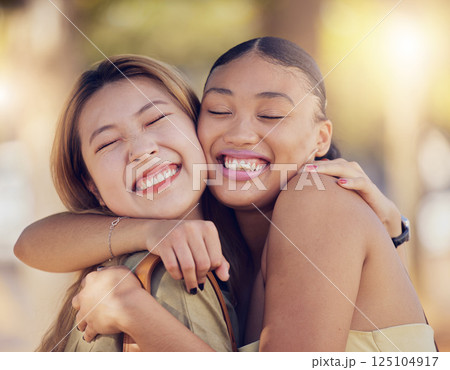 Friends, women and hug for love, care and support while outdoor for travel, happiness and bonding with asian and black woman. Lesbian couple with a smile in nature for peace, summer and time together 125104917