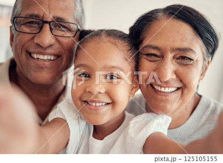 Phone selfie of child, grandparents or happy family bonding, having fun and enjoy quality time together at home. Love, smile and photo memory portrait of grandmother, grandfather and young kid girl 125105155
