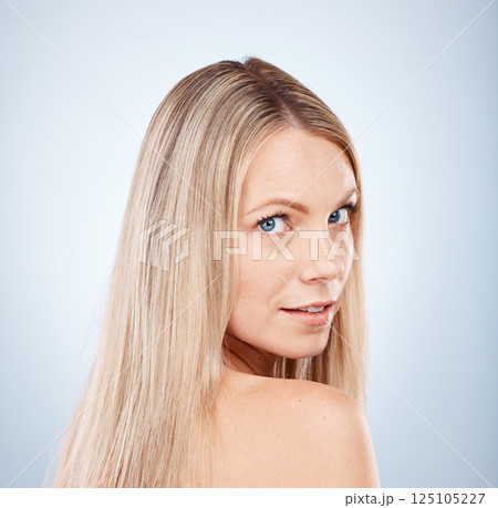 Hair, woman and portrait of a blonde woman with hairstyle or treatment for beauty and haircare. Hair style, hair care and blond female face for aesthetic, clean healthy hair in a studio salon 125105227