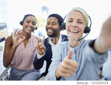 Call center, selfie and employees with hand sign for support, motivation and thank you in telemarketing business. Thumbs up, photo and portrait of customer service people excited about consulting Call center, selfie and employees with hand sign for support, motivation and thank you in telemarketing business. Thumbs up, photo and portrait of customer service people excited about consulting 125105314