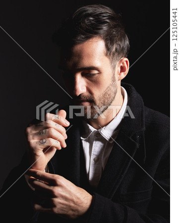Fashion, style and man model in studio with confidence in stylish, fancy and fashionable clothes. Handsome, confident and young male in luxury or designer outfit isolated by dark or black background. Fashion, style and man model in studio with confidence in stylish, fancy and fashionable clothes. Handsome, confident and young male in luxury or designer outfit isolated by dark or black background. 125105441