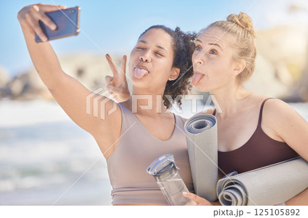 Happy face selfie, yoga and women with yoga mat exercise at the beach for fitness workout, spiritual health and zen meditation. Fun with a friend, stress relief and pilates wellbeing workout training 125105892