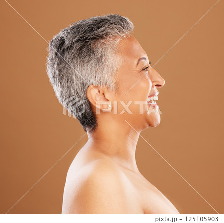 Mature woman, face and skincare glow on studio background profile in wellness, dermatology or self care. Smile, happy or Indian beauty model with gray hair, makeup cosmetics or anti aging cosmetology Mature woman, face and skincare glow on studio background profile in wellness, dermatology or self care. Smile, happy or Indian beauty model with gray hair, makeup cosmetics or anti aging cosmetology 125105903