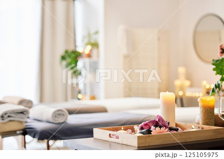 Candle, spa and relax with aromatherapy treatment in a tray in a room for luxury or wellness. Background, health and massage with still life in an empty resort for peace, skincare or relaxation Candle, spa and relax with aromatherapy treatment in a tray in a room for luxury or wellness. Background, health and massage with still life in an empty resort for peace, skincare or relaxation 125105975