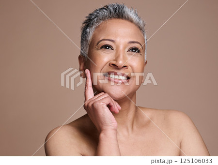 Face, beauty and skincare with a mature model woman in studio on a brown background thinking about wellness. Luxury, cosmetics and antiaging with a senior female posing to promote a skin product 125106033